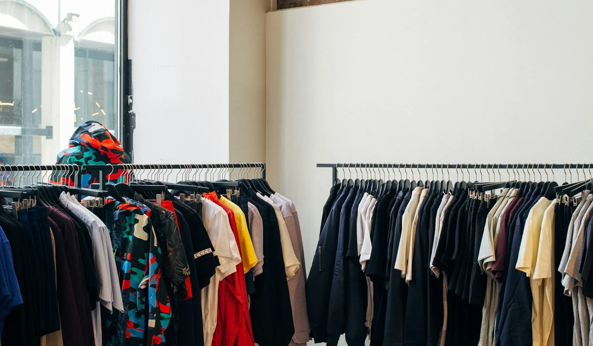 Rails of garments in a boutique, hung in dense repeated rows
